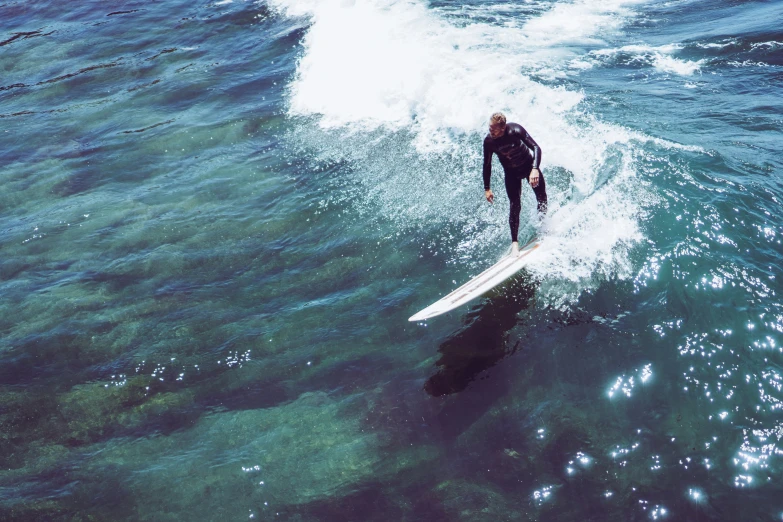 a man in black suit on white surfboard