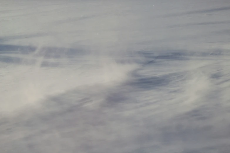 a man riding a snow board on top of a snow covered slope