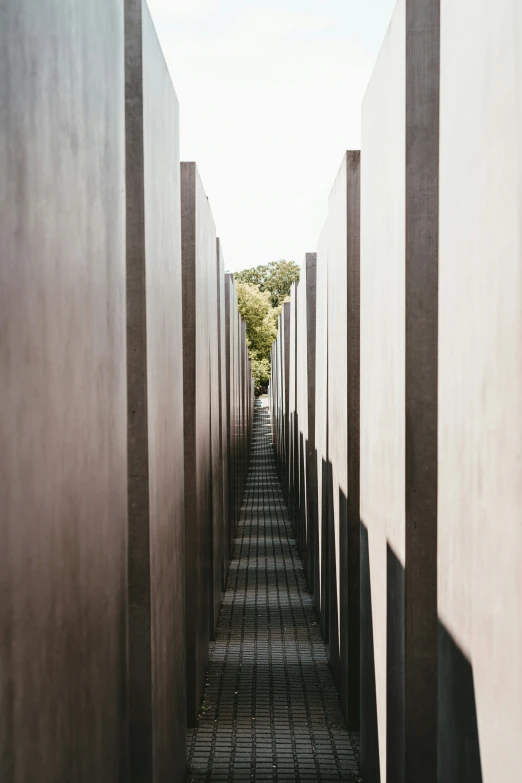 the long straight concrete wall has a wire walkway to it