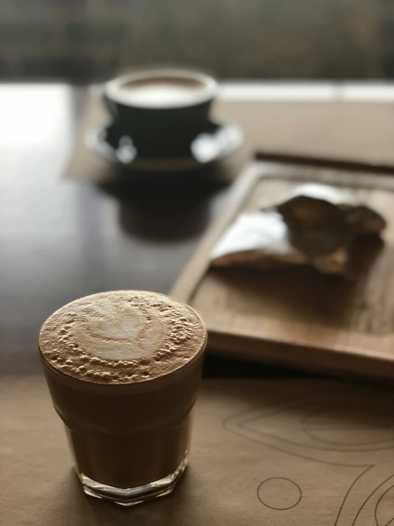 a small glass and a plate on a table