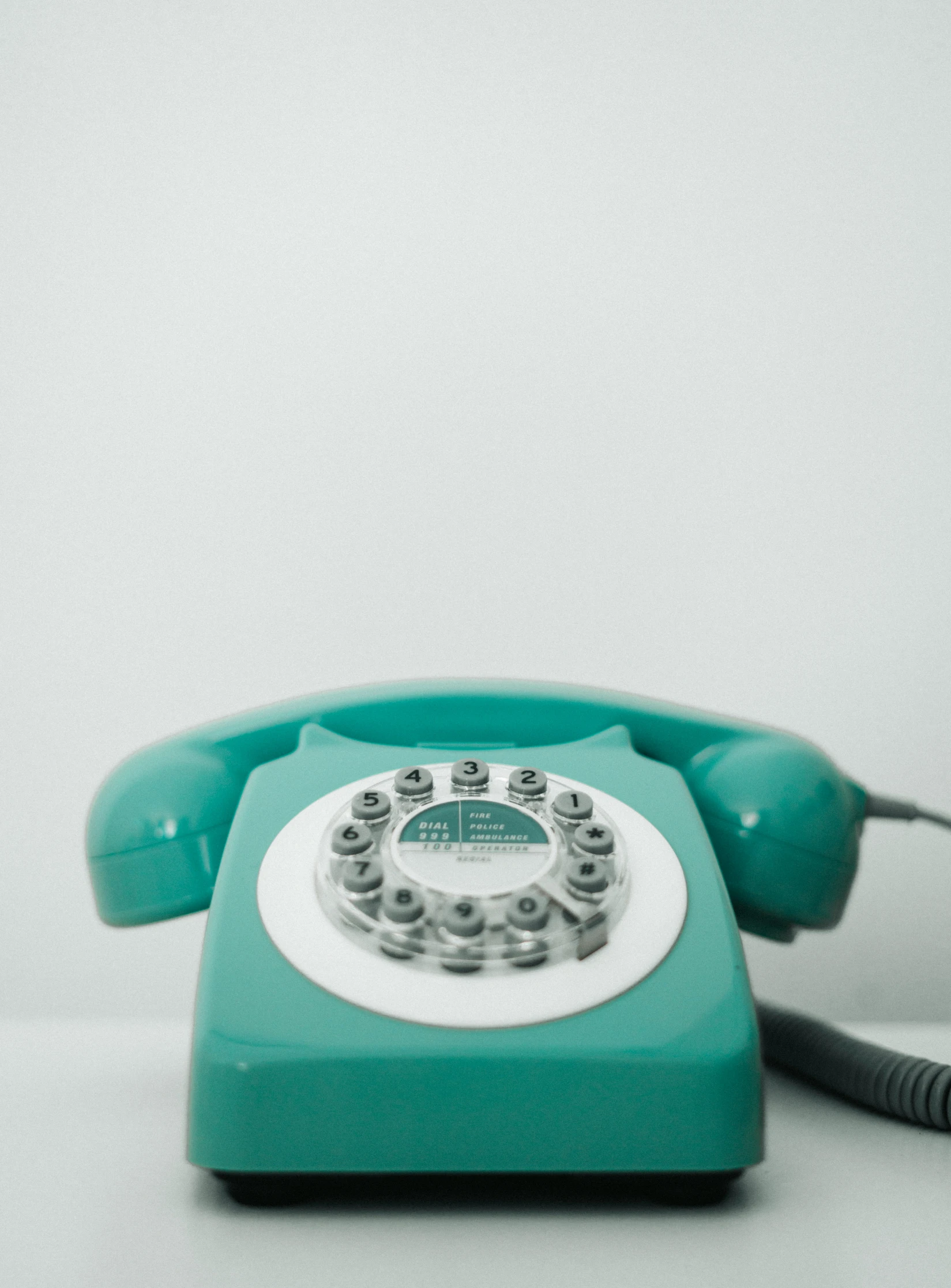 a rotary telephone with three hands is turned on