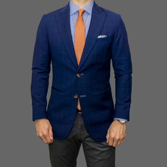 a man in a blue jacket and orange tie