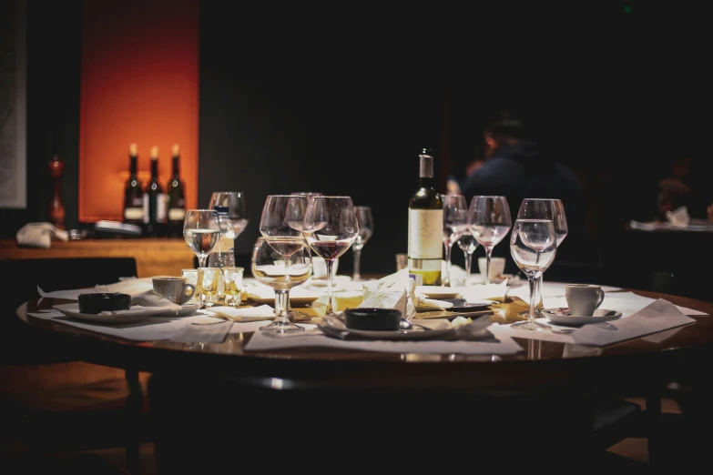 a wine glass and cheese dish set up on a table