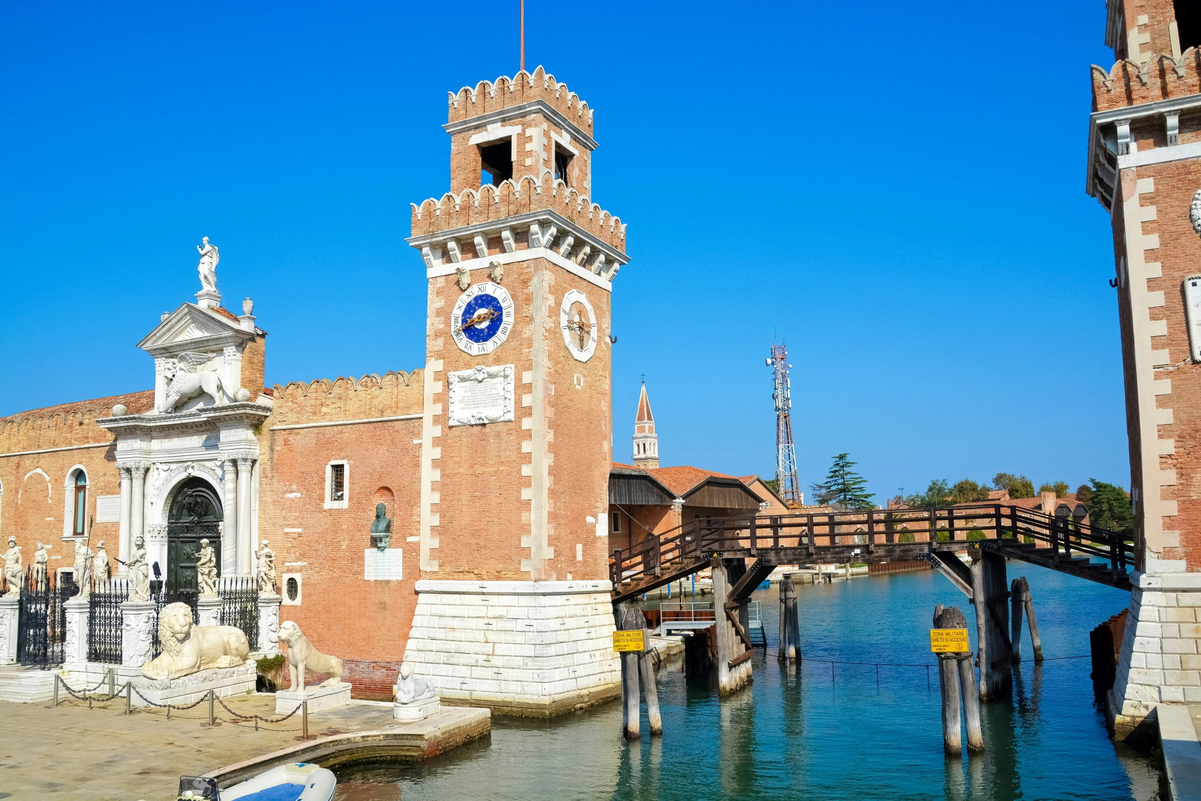 a clock tower sits on the edge of the water