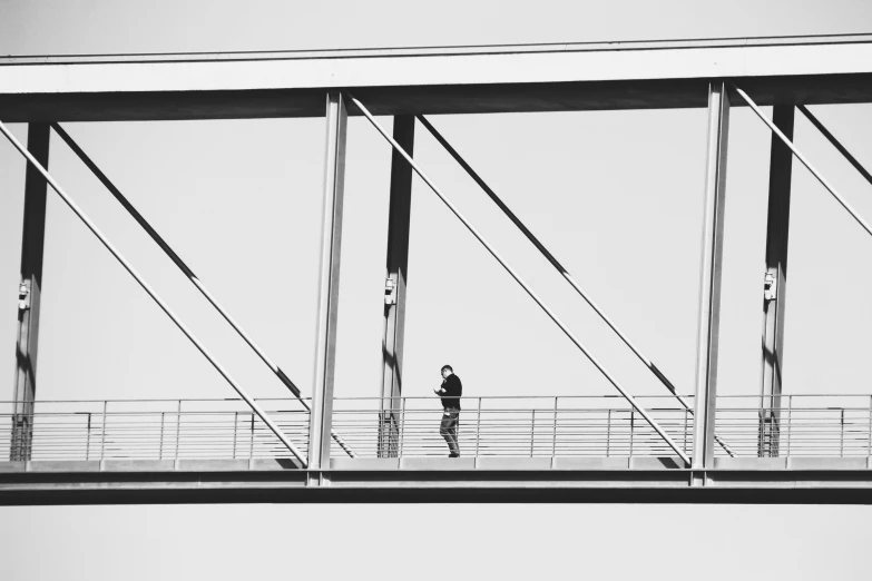 an image of person walking across the bridge