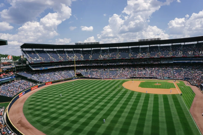 a huge baseball field that has people on it