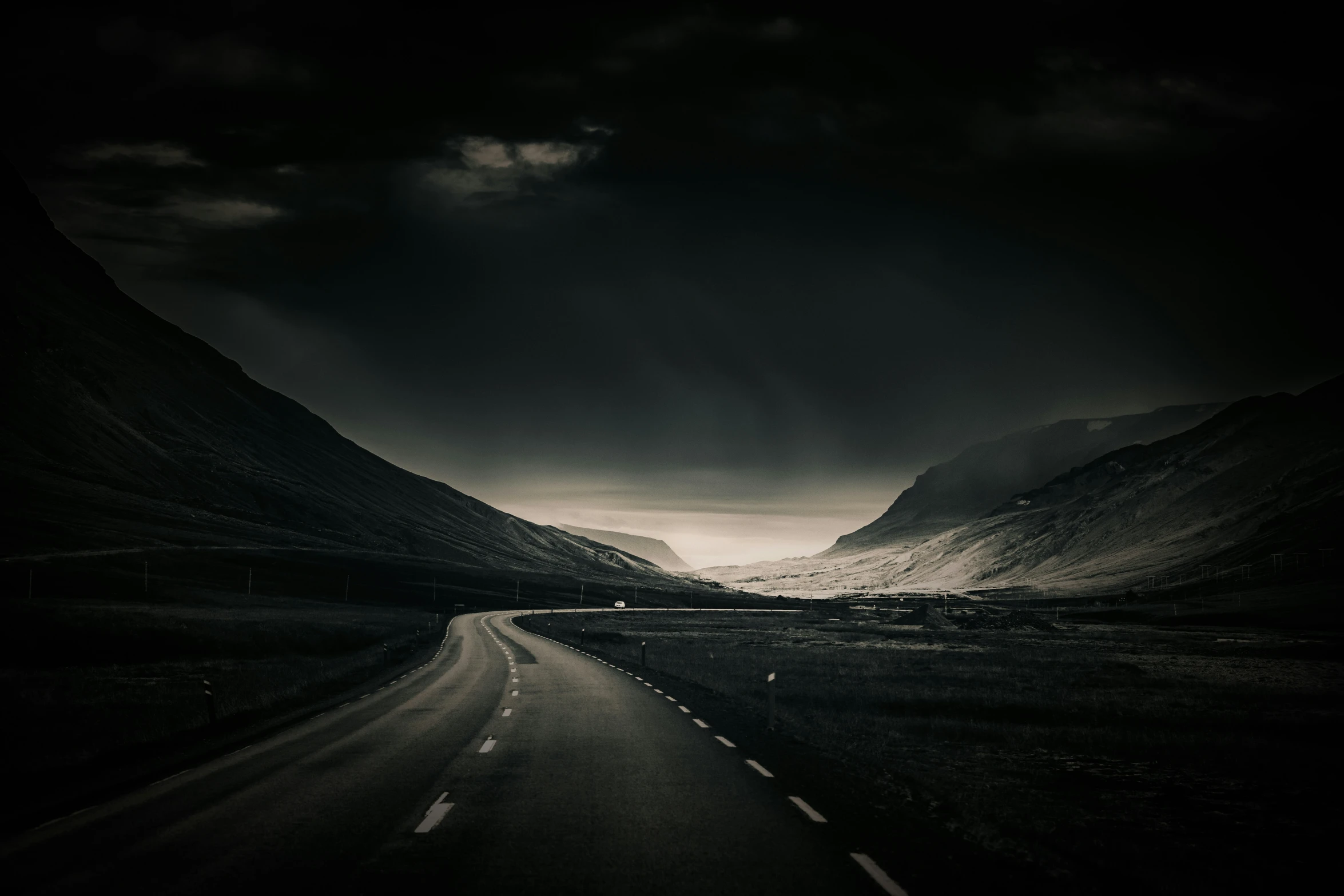 a black and white po of mountains on a cloudy day