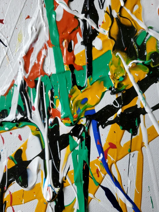 an assortment of paint strokes and drops on canvas