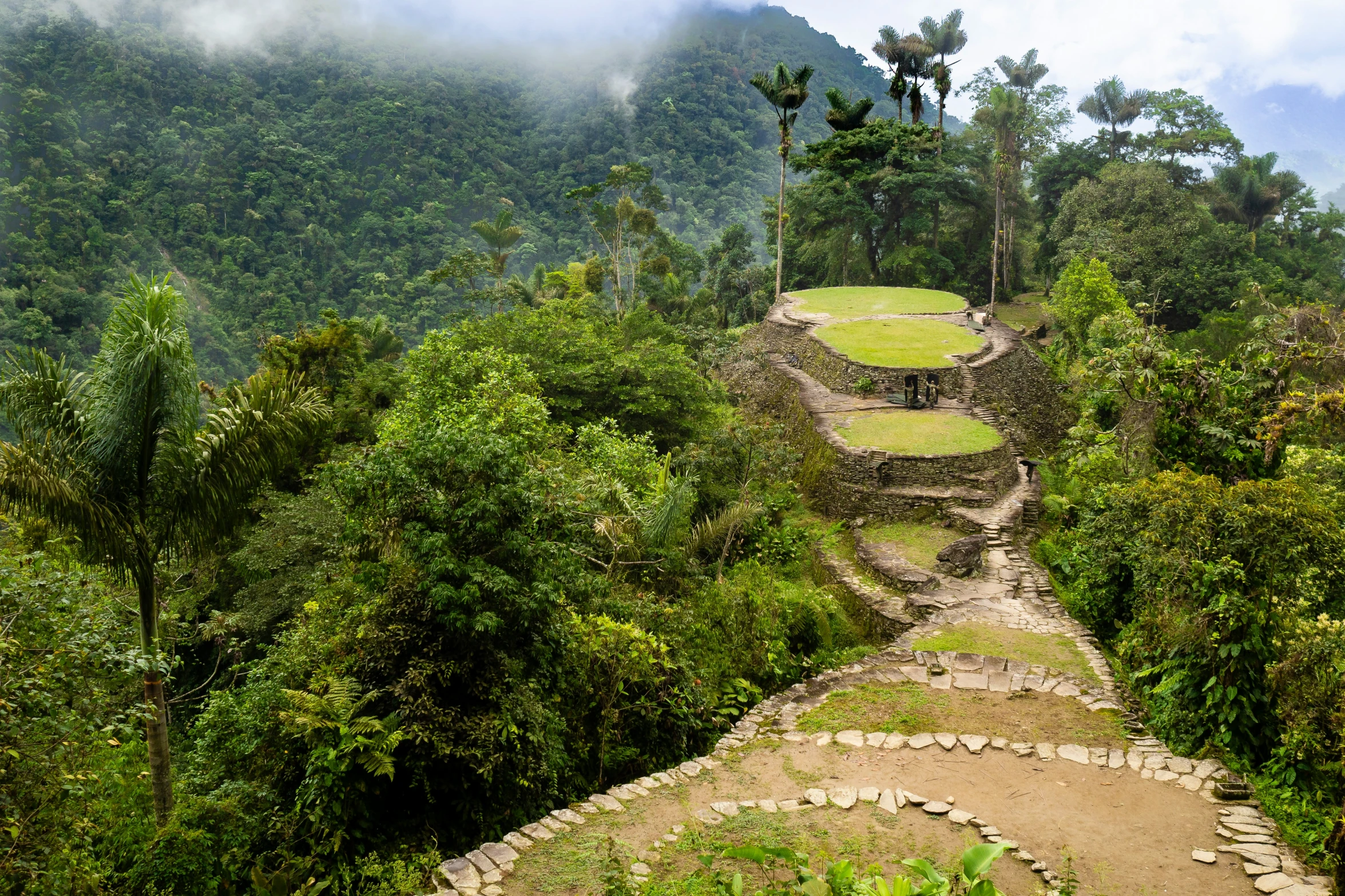 an old ruin in a tropical setting surrounded by trees