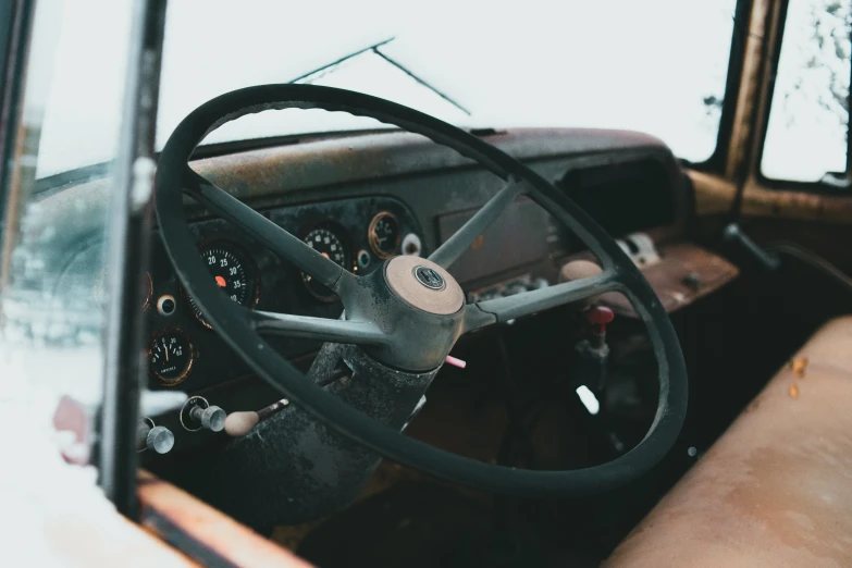 the steering wheel and dashboard of an old car