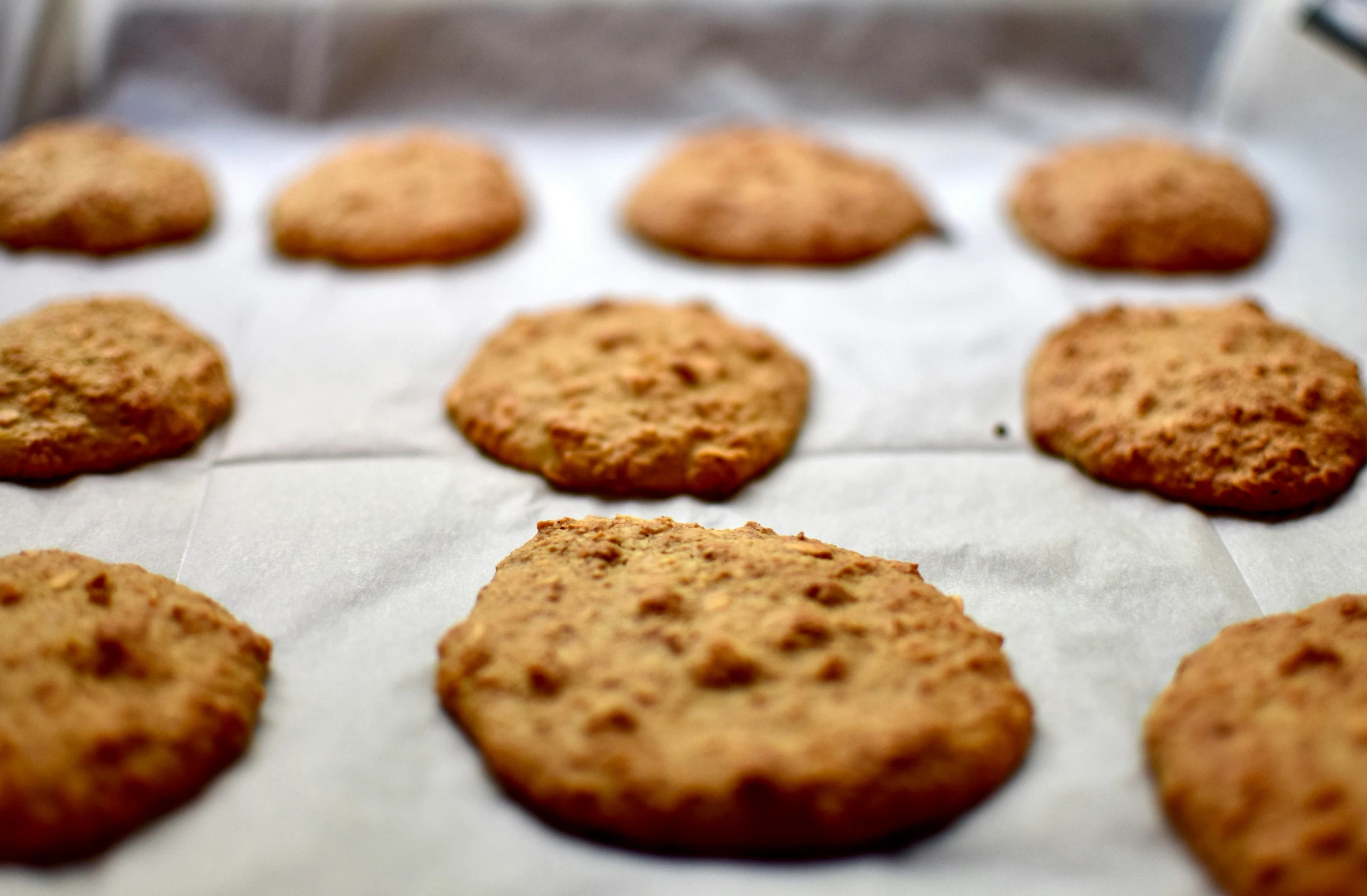 a tray with some cookies on top of parchment paper