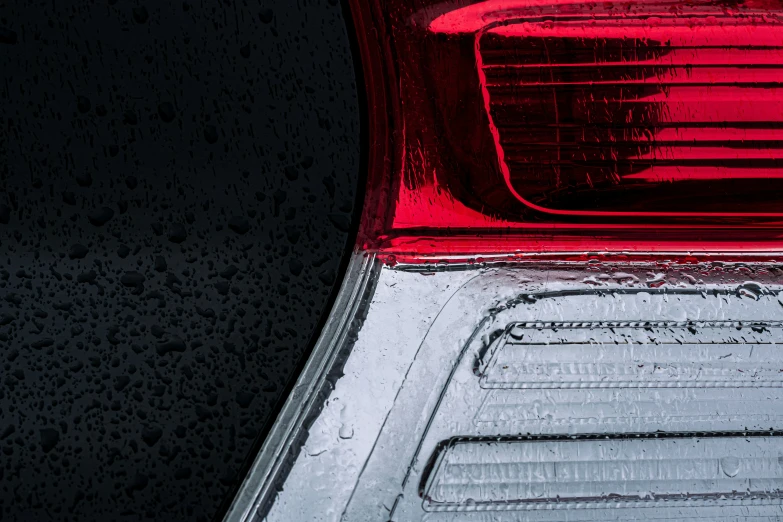 a car tail light with rain and water drops