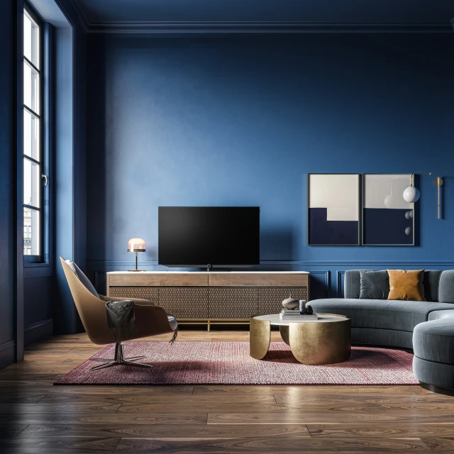 a living room with blue walls and an upholstered sectional