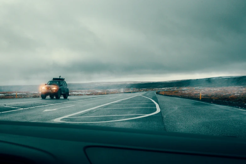 an overcast day with cars going down the road