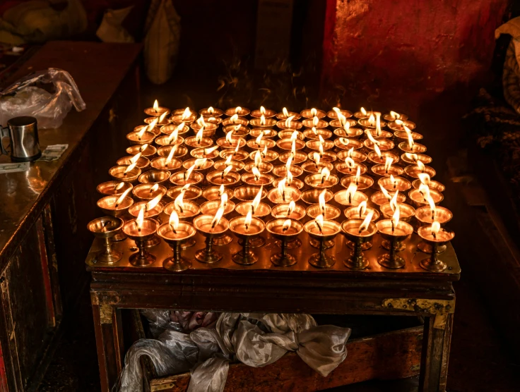 rows of candles on display inside a storage room