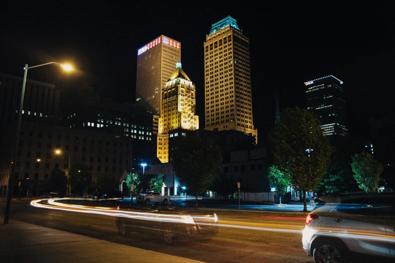 cars moving through the street at night time