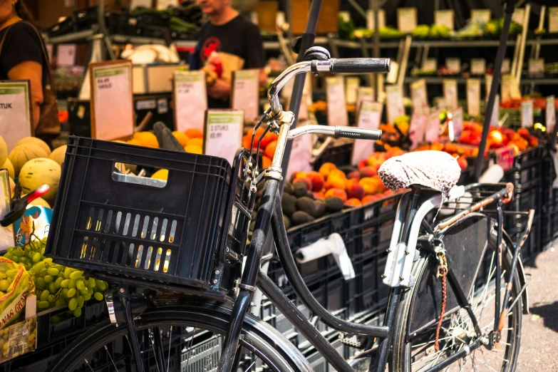 a bike is next to crates of fruit