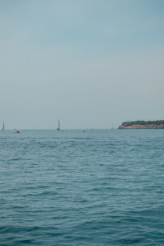 a group of boats sailing in the distance