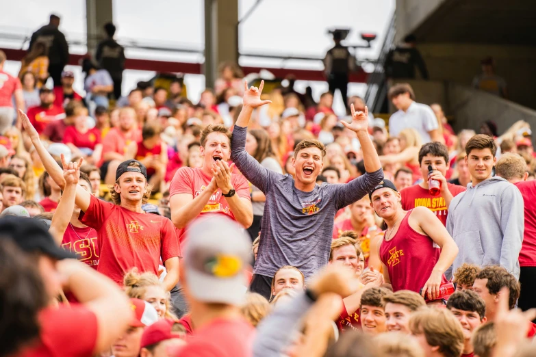 a crowd of people cheer for soing at a sporting event