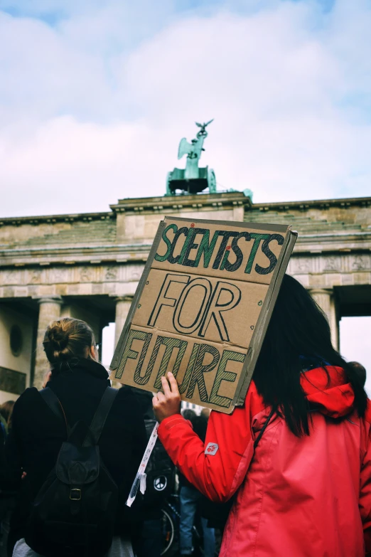 protestors holding signs at a demonstration with the word sentts for future