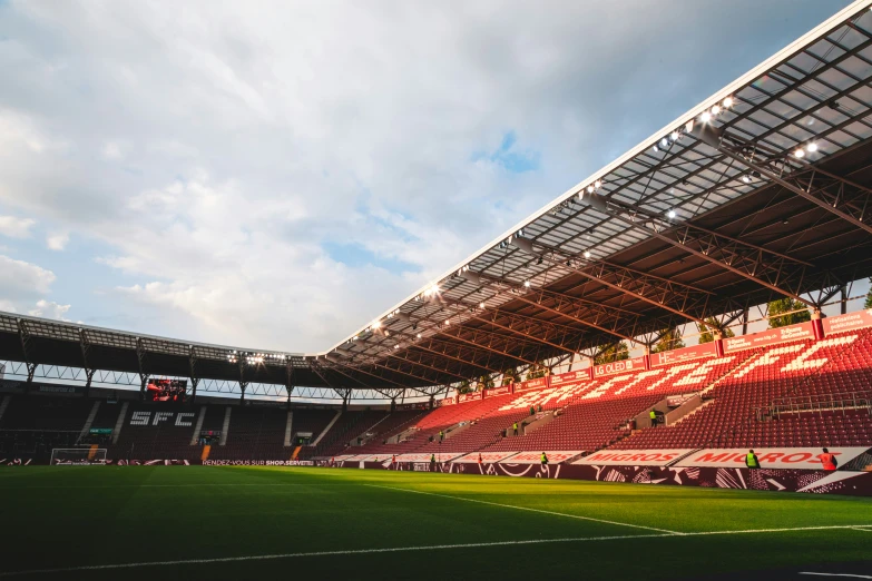 a soccer stadium is under a cloudy blue sky