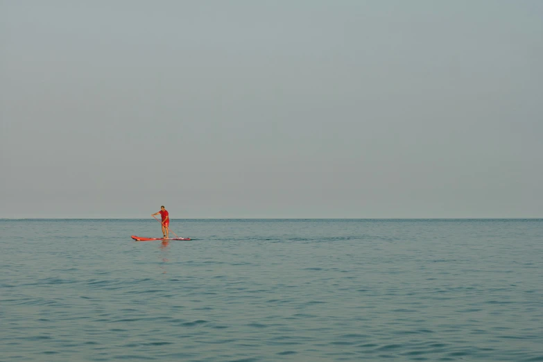 a man rowing a boat on a large body of water