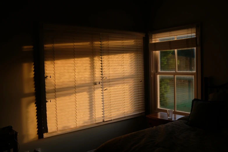 a bedroom with the light shining in from the window