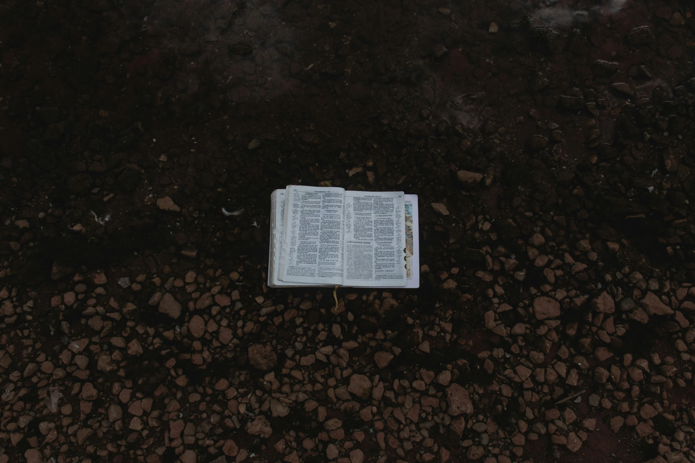 a book laying on a ground next to a street