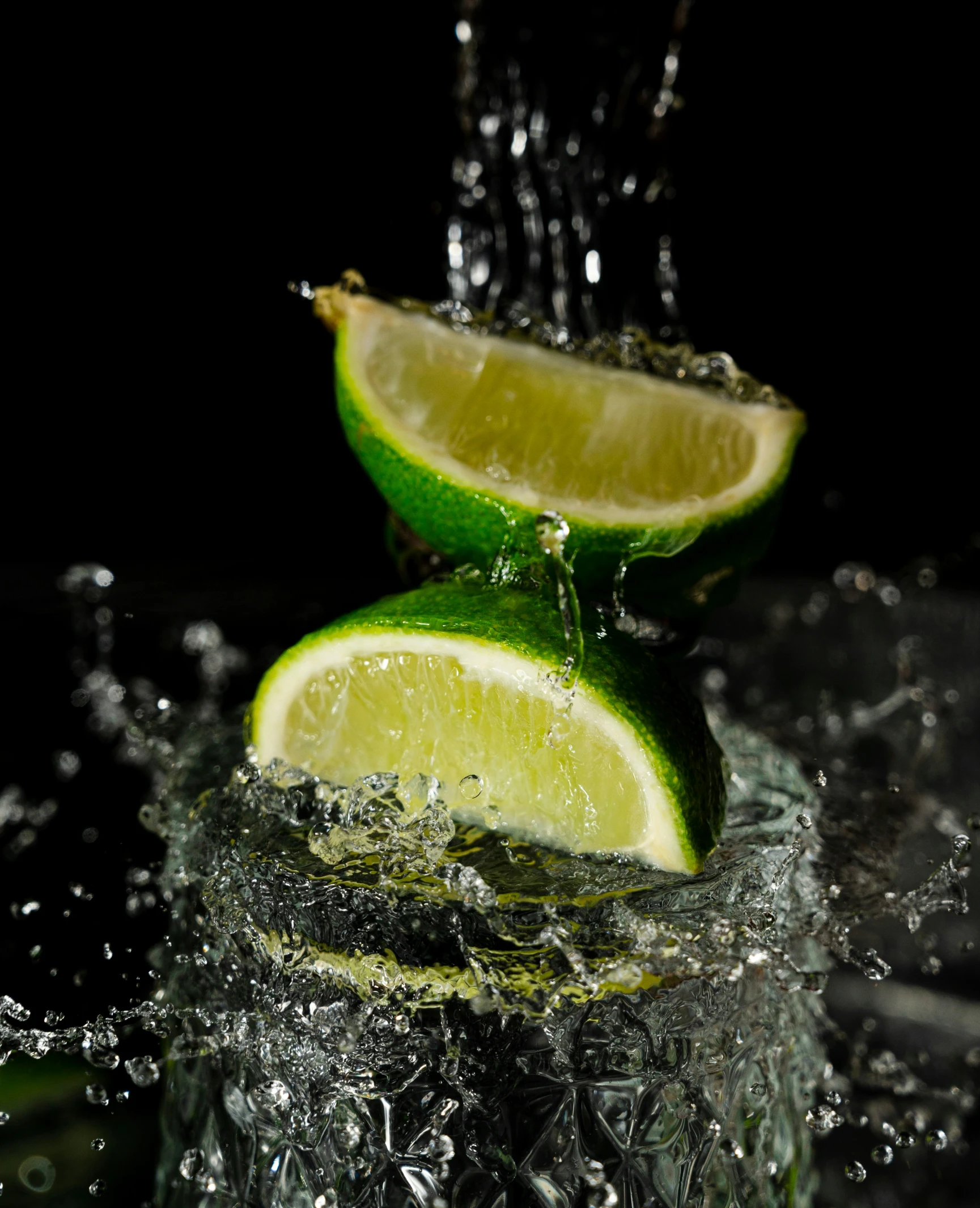 two limes sitting on top of a pile of ice