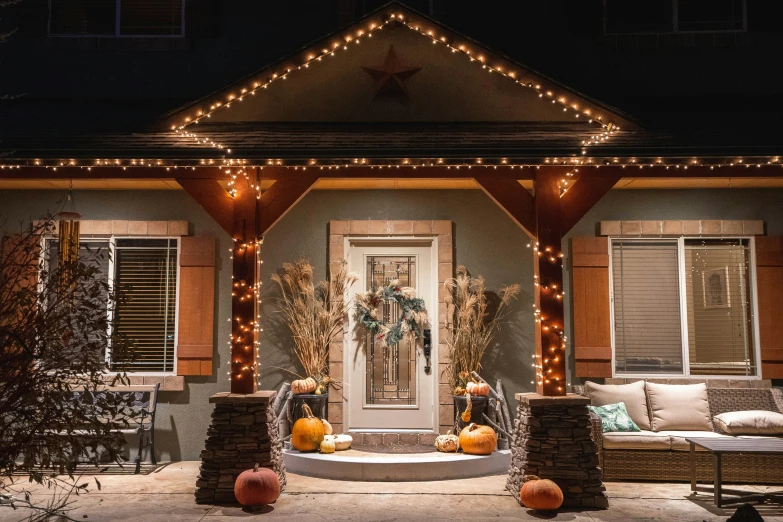 a couple of pumpkins sit on the porch of their home