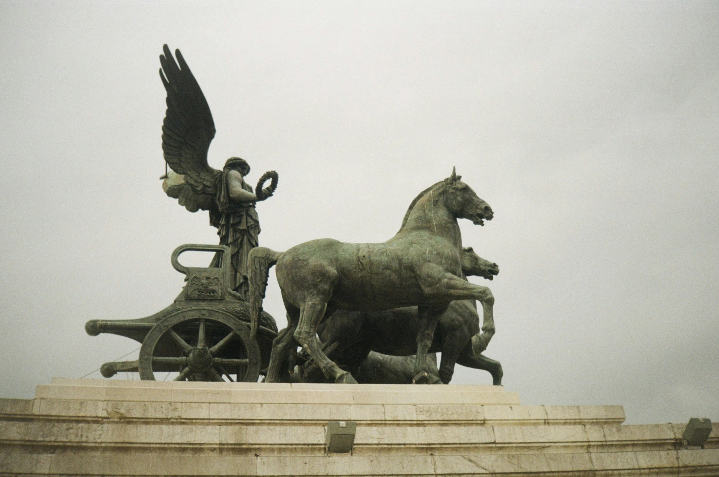 a statue of an angel sitting on top of a horse carriage