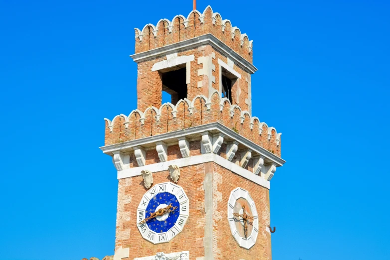 a tall clock tower with clocks on the outside