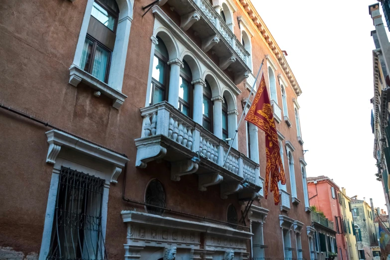 buildings along the street with banners hanging from the windows