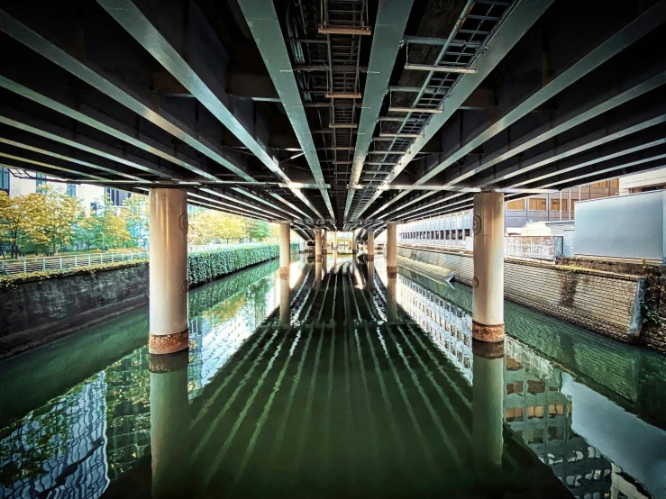 the view from underneath of a large bridge