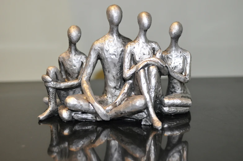 a silver statue is sitting on a black table