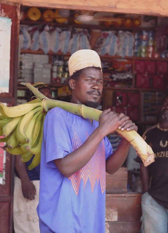 a man carries bananas at the market in africa