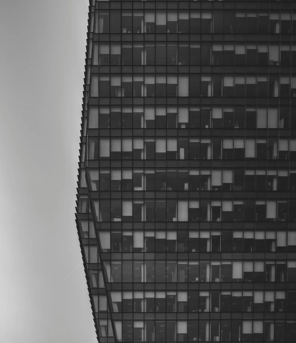 a bird flying next to a large tall building