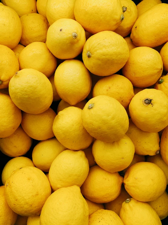 yellow lemons on display in a supermarket or store