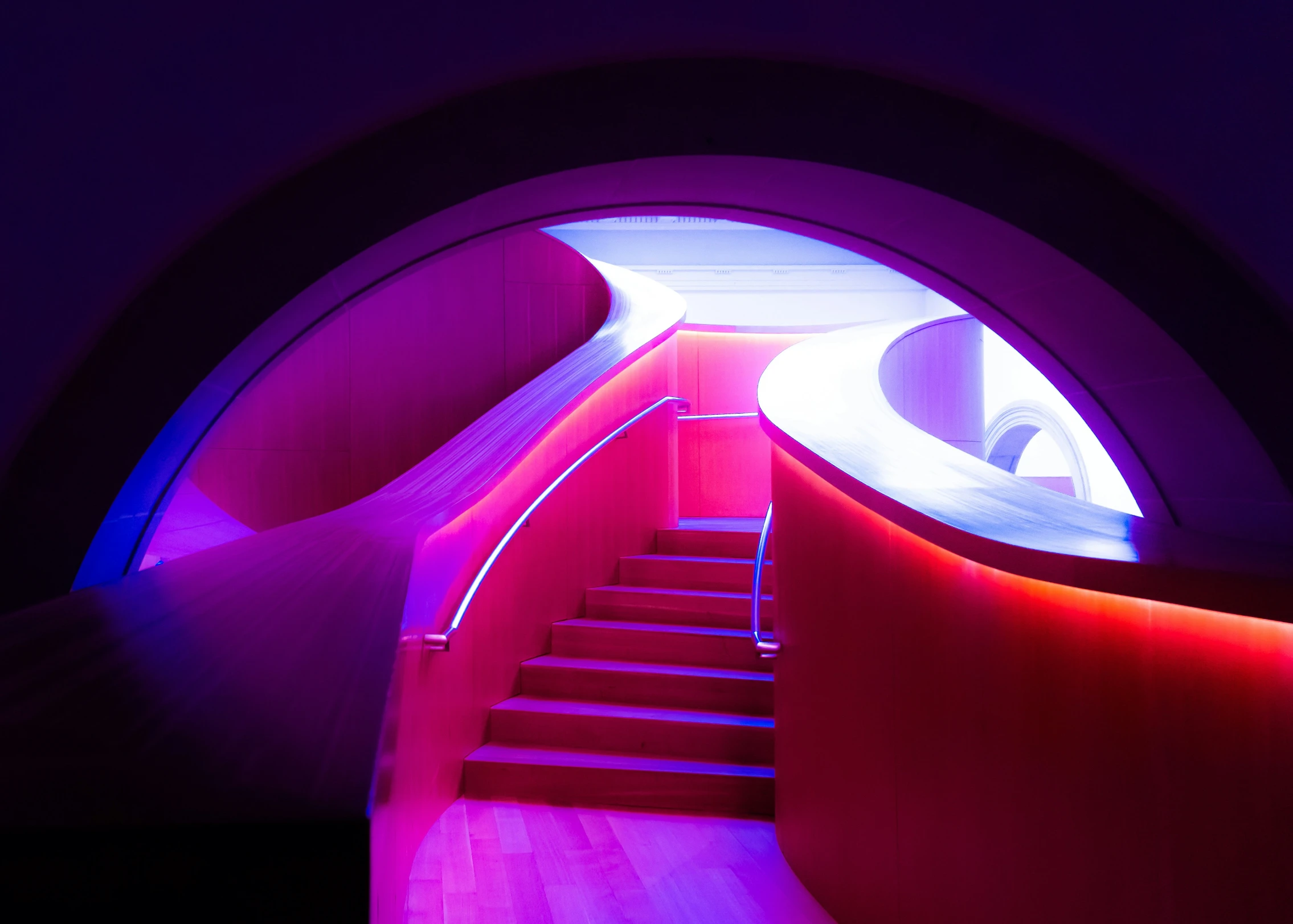 a long red staircase leads to a purple tunnel with stairs