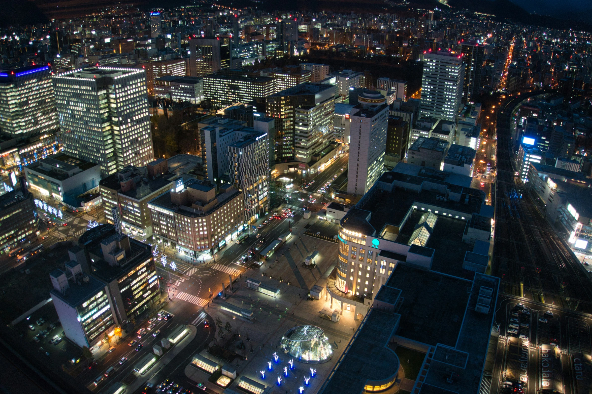 city lights shining over buildings at night