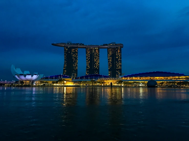 the building is illuminated up in blue lights