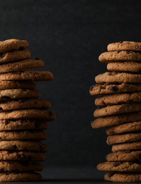 two chocolate chip cookies stacked next to each other