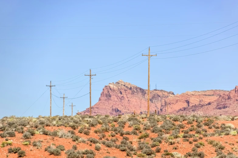 power lines stretching across a desert plain