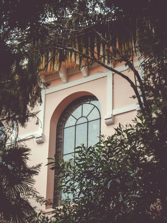 an image of a pink building and window