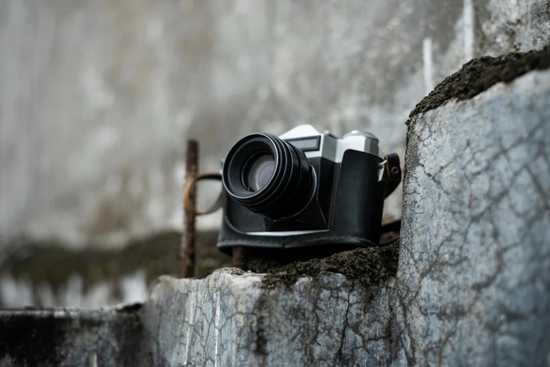 a camera on a rock next to an outdoor table