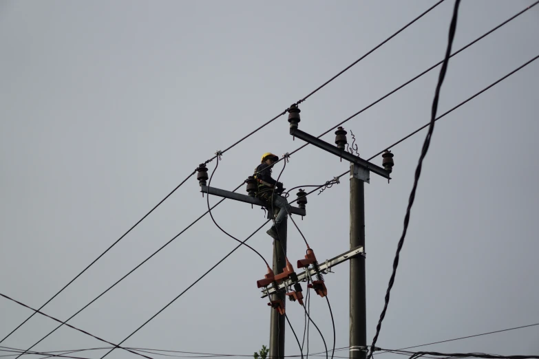 the electric worker is busy on the wire