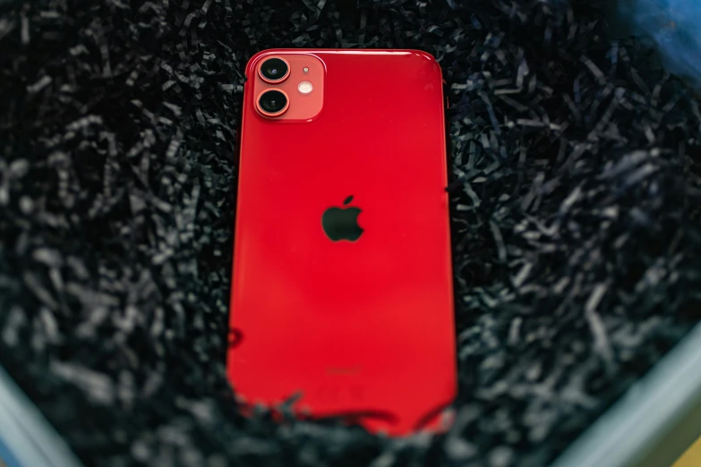 an apple phone in a pile of carpet