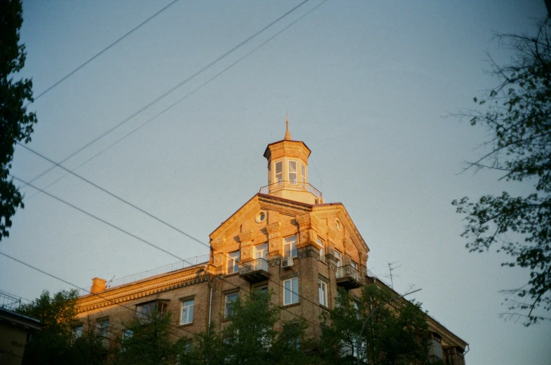 the tower and top of an old building at dusk