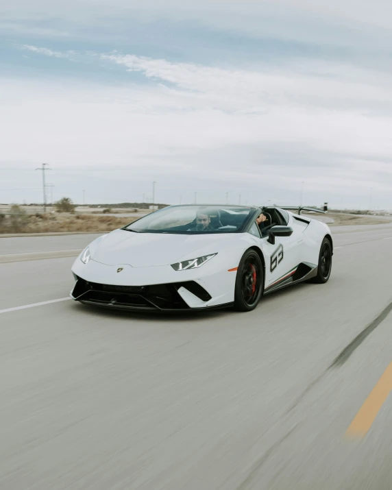 a white sports car on a freeway