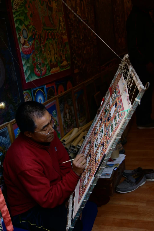 a man holding a large piece of art